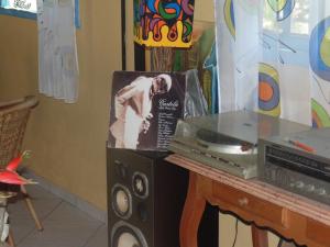 a table with a picture of a man next to a microwave at Repousada Sana in Sana