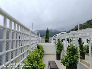 a white fence with plants and benches on a balcony at A5 Barrington Square 1 Room Apartment in Cameron Highlands