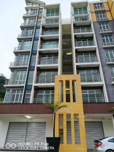 a tall apartment building with a sculpture in front of it at A5 Barrington Square 1 Room Apartment in Cameron Highlands