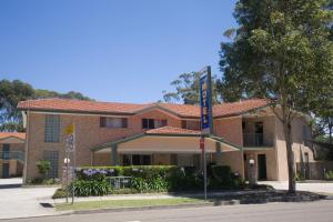 a brick building with a sign in front of it at Chittaway Motel in Tuggerah +19 photos