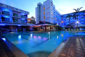 a large swimming pool in front of a building at Wild Orchid Resort in Angeles