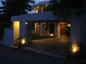 a house with lights in front of it at night at Silvikris Villa in Colombo