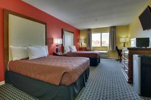 a hotel room with two beds and a flat screen tv at Heritage Grand Inn in Canton +48 photos