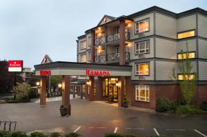 a large building with a kamuki sign in front of it at Ramada by Wyndham Nanaimo in Nanaimo