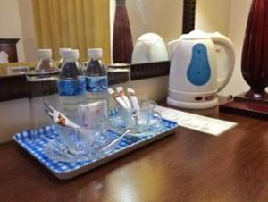 a tray of toothbrushes and bottles of water on a table at Cindy Kelly Hotel in Olongapo
