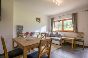 a living room with a table and a couch at Ferienhof Formegg in Hopfgarten im Brixental