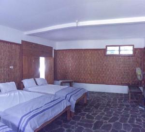 una camera d'albergo con due letti e una finestra di Omah nDeso Argopeni a Srumbung