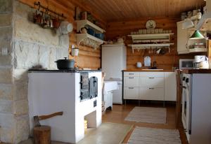 a kitchen with a white stove in a room at Toominga Seaside Cottage in Kõiguste