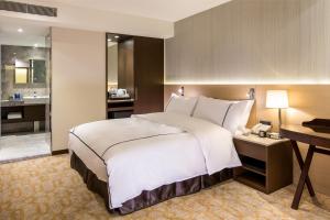 Postel nebo postele na pokoji v ubytování K Hotel Tianjin