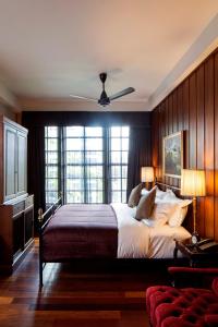 a bedroom with a large bed with a ceiling fan at Bangkok Publishing Residence in Bangkok