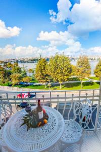 a table with a bottle of wine on top of a balcony at Hotel Troya Balat in Istanbul