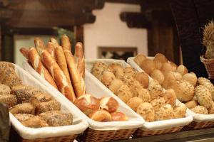 a display of bread and pastries in baskets on a counter at Landhaus Sackmann in Baiersbronn