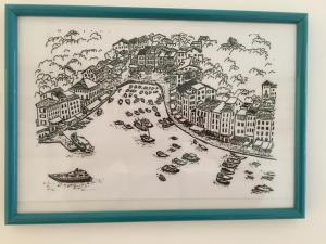 a framed drawing of a city with boats at Jolie Maison in Santa Margherita Ligure