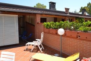 eine Terrasse mit Stühlen und Pflanzen auf einem Backsteinhaus in der Unterkunft Sole e Luna in Pontecagnano