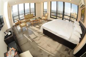 a bedroom with a bed and a table and chairs at Sindyan Resort in Al Salt +48 photos
