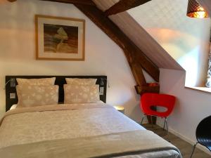 A bed or beds in a room at Moulin de la Fayolle
