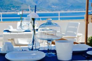 a table with a blue table cloth with a glass bottle at Il Bottone al Duomo in Gaeta