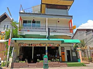a building with a restaurant with a balcony at Love CNX Guesthouse in Chiang Mai