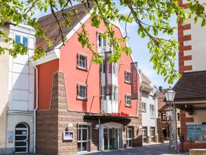 a building in the middle of a street at DORMERO Hotel Villingen-Schwenningen in Villingen-Schwenningen