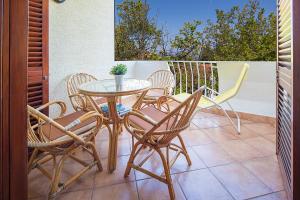 a table and chairs sitting on a patio at Apartments Bo in Malinska