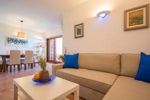 a living room with a couch and a table at Apartments Bo in Malinska