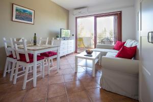 a living room with a table and a dining room at Apartments Bo in Malinska +12 photos