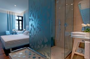 a bathroom with a shower and a bed in a room at JR Hotels Bari Grande Albergo delle Nazioni in Bari