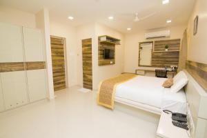 a bedroom with a large bed and a bathroom at KK Inn in Gūduvāncheri