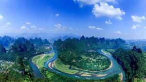 an aerial view of a river in the mountains at Yangshuo Yunshe Mountain Guesthouse in Yangshuo