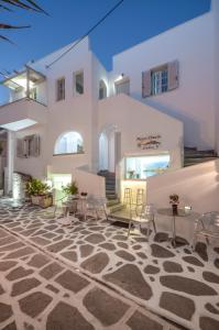 patio z krzesłami i stołami przed budynkiem w obiekcie Naxos Dream Aphrodite Studios w mieście Naksos