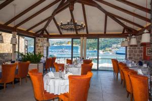 a restaurant with tables and chairs and a view of the water at Bova Luxury Rooms in Dubrovnik