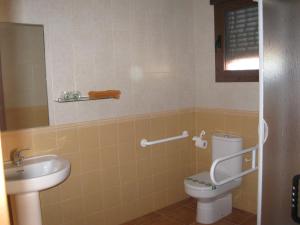 a bathroom with a toilet and a sink at Hostal Sol de la Vega in Albarracín +38 photos