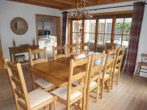 a dining room with a wooden table and chairs at Ado's Haus in Niederau