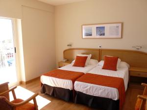 Postel nebo postele na pokoji v ubytování Hotel Tanit