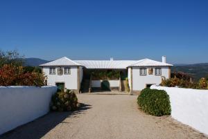 uma casa branca com uma cerca e uma entrada em Quinta da Calçada em Melgaço