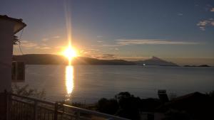 a sunset over a large body of water at Villa Elli in Ammouliani +5 photos