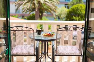 a table and two chairs on a balcony at Apartments Marija in Vela Luka