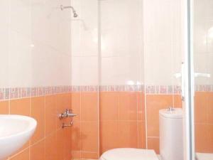 a bathroom with a toilet and a sink at Pegasus Motel in Avşa Adası