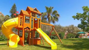 a playground with a slide in a park at Hadjios Valley in Mazotos