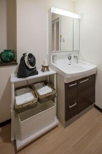 a bathroom with a sink and a mirror at Kyonoyado Senkaku Bettei in Kyoto