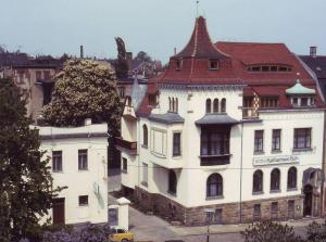 a large white building with a red roof at Hotel Katharinenhof in Werdau