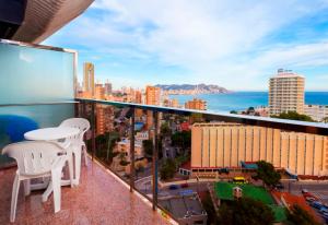 a balcony with a table and chairs and the ocean at Gran Hotel Bali in Benidorm
