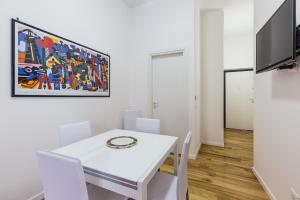 - une salle à manger blanche avec une table et des chaises blanches dans l'établissement B&B Albatros Centro Storico Palermo, à Palerme