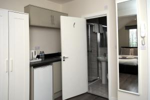 a room with a bathroom with a sink and a toilet at Guest House London in London
