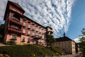 a building on a hill with a cloudy sky at Hotel Terra in Janske Lazne