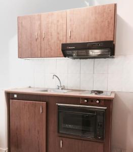 a kitchen with a sink and a microwave at Calypso Beach Hotel in Loutra Edipsou +57 photos