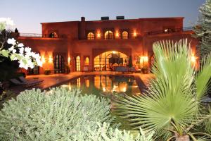 a house with a swimming pool in a yard at Villa TYCOZ in Marrakesh