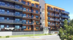 an apartment building with balconies on the side of it at Žiogų apartamentas in Palanga