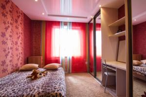 a bedroom with a bed with a stuffed animal on it at Kirova 115 in Novokuznetsk