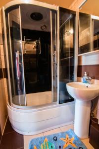 a bathroom with a shower and a sink at Kirova 115 in Novokuznetsk